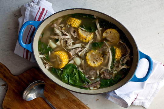 Overhead view of Ajiaco con Pollo, Colombian chicken and corn soup in stew pot