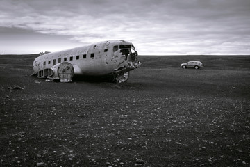 Dc3 plane wreck at solheimsandur beach in Iceland with car in the back. Black lava sand.