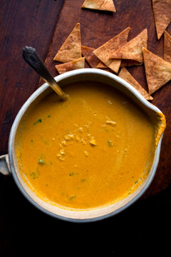 Lemon, carrot and tahini soup served in bowl with pita crisps