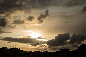 Sunset in the city between clouds.