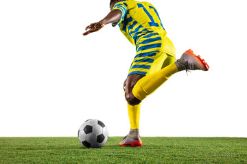 Professional african-american football or soccer player of yellow team in motion isolated on white studio background. Fit man in action, excitement, emotional moment. Concept of movement at gameplay.
