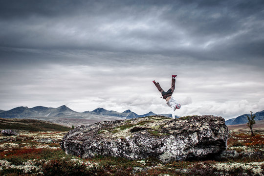 Man Doing Handstand In Mountain Scenery.