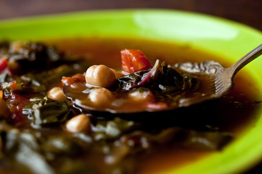 Close up of Valencian chickpea and chard soup served in bowl