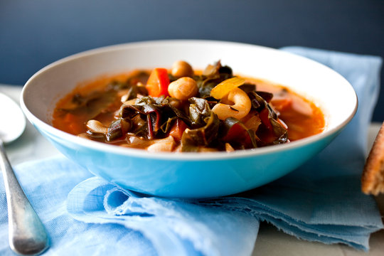 Close up of chard and chickpea minestrone soup served in bowl