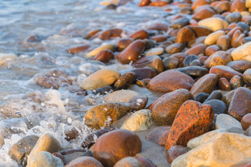 azure waves on a stony beach under the sun