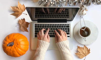 Top view of woman typing laptop in Autumn