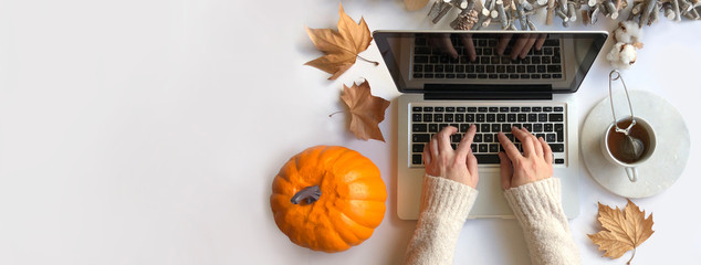 Top view of woman typing laptop in Autumn