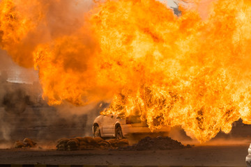 Close up of a Military strike or bomb in war on a car causes fire ball and explosion in the town in chaos. Military war concept. Strength, power, force, fire, explosion.