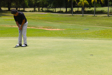 Golfer playing golf in beautiful golf course in the evening golf course with sunshine in thailand