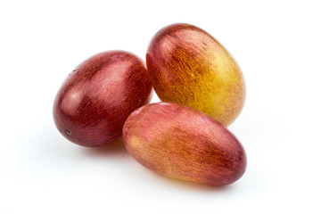 Three berries of pink grapes isolated on a white background.