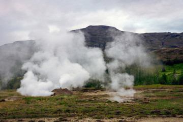 Smoke at geothermal area, blue hour in Haukadalur in Iceland. Strokkur and nature concept.