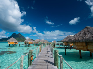 BORA BORA, FRENCH POLYNESIA - SEPTEMBER 5, 2018 - Luxury overwater villas on blue lagoon, white...