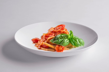 Elegant White round bowl with spaghetti tomato and basil
