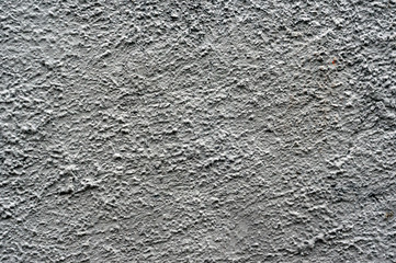 Rough dark gray relief plastered wall. Blank texture, background, blank for designers