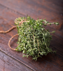 Bunch of garden thyme herb on wooden table