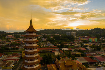 Aerial view of Chinese Temple Peak Nam Toong Pagoda during twilight sunset located in the city of Kota Kinabalu, Sabah, Malaysia.