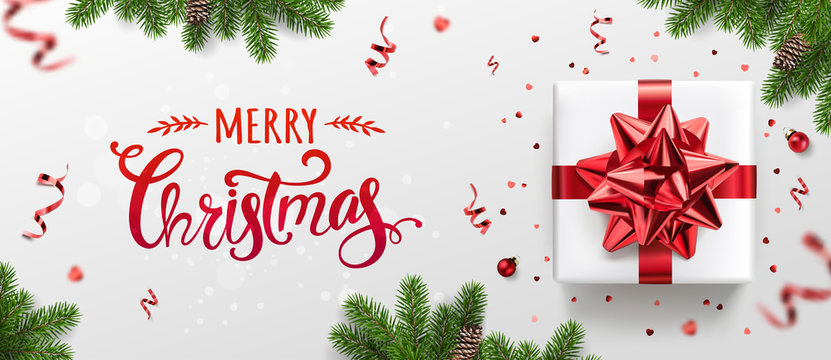 Merry Christmas card with holiday text, gift boxes, fir branches, red ribbons and bow, sparkles, confetti, bokeh on light background. Xmas and New Year holiday. Vector Illustration, realistic vector