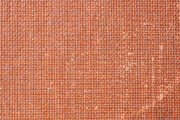 Fragment of a red textured cover of an old book. Background and backdrop. Vintage