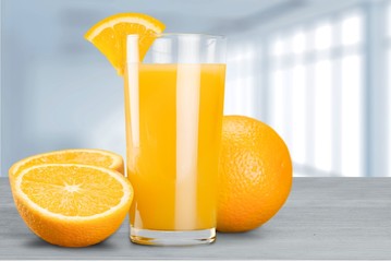 Orange juice and slices of orange on background