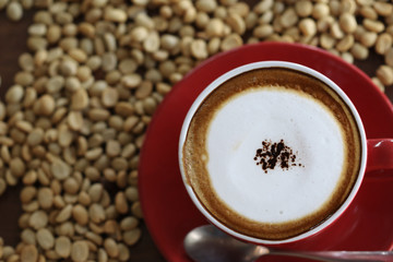 Cup of cappuccino with latte art on wooden background. Latte Coffee art on the wooden table. cup of coffee on table in coffee shop cafe;