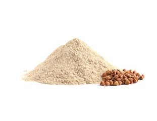 Pile of buckwheat flour and grains on white background