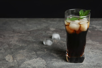 Refreshing soda drink with ice cubes and mint on grey table. Space for text