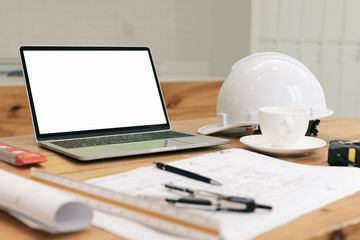 Architectural plan, laptop, dividers ,pencil ,pen ,ruler, glasses and smartphone and blueprint on...