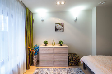 Bedroom in modern apartment. Interior. Light spacious room. King-size bed.