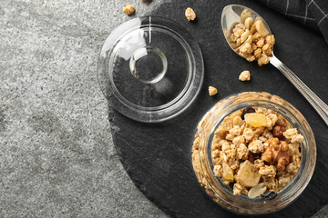 Tasty homemade granola on grey table, flat lay. Healthy breakfast