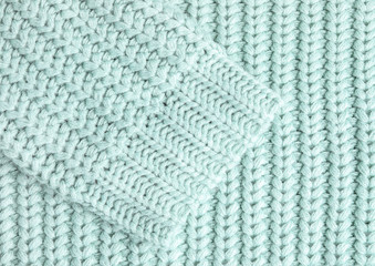 Warm knitted sweater as background, closeup view