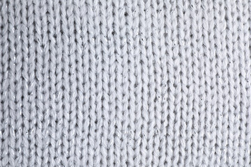 Warm knitted sweater as background, closeup view