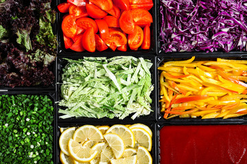 Salad bar with different fresh ingredients as background, top view