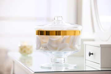 Jar with cotton pads on dressing table indoors
