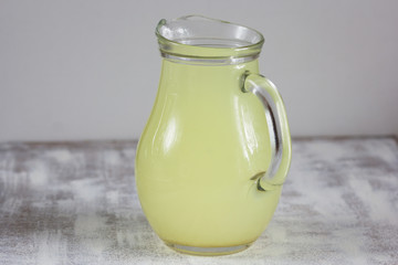 Liquid whey that remains after formation of curds in jar on white background