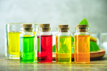 Closeup four organic oil in the bottles on the table for produce apothecary cosmetic product.
