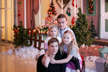 Fototapeta na wymiar family in christmas decorations smiling and hugging