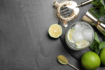 Cocktail with vodka and lime on grey table, flat lay. Space for text