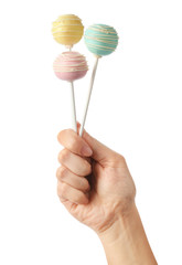 Woman holding sweet cake pops on white background, closeup