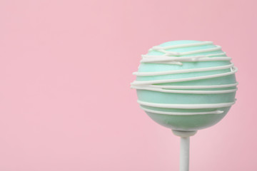 Sweet decorated cake pop on pink background, space for text