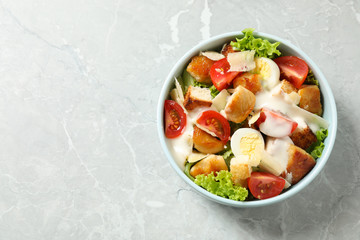 Delicious fresh Caesar salad on grey marble table, top view. Space for text