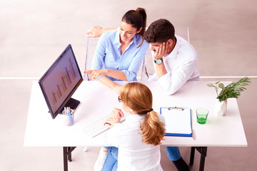 Shot of investment advisor businesswoman and young couple sitting in the office and consulting