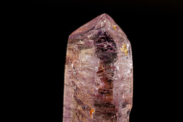 macro mineral amethyst stone on a black background