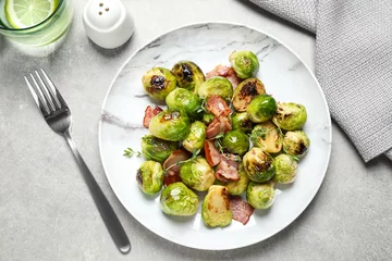 Rolgordijnen Delicious Brussels sprouts with bacon served on light table, flat lay © New Africa