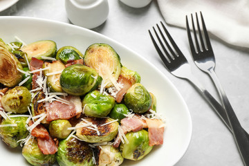 Delicious Brussels sprouts with bacon served on light table