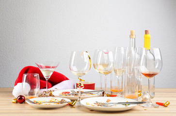 Dirty dishes with leftovers on wooden table after party