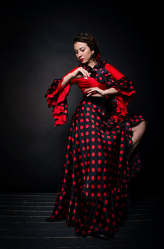 Carmen beautiful woman in red dress on dark background