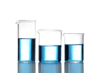 Beakers with blue liquid isolated on white. Laboratory glassware