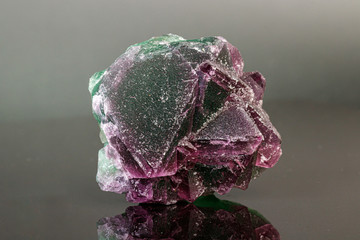 macro mineral stone green and purple fluorite on a black background