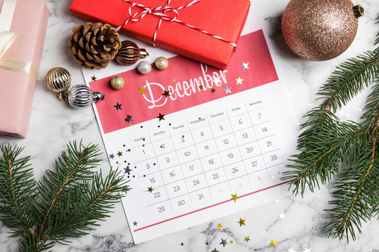 Flat lay composition with paper calendar on white marble table