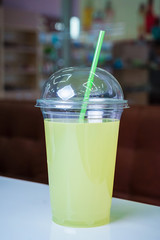 Mojito in a plastic glass on table